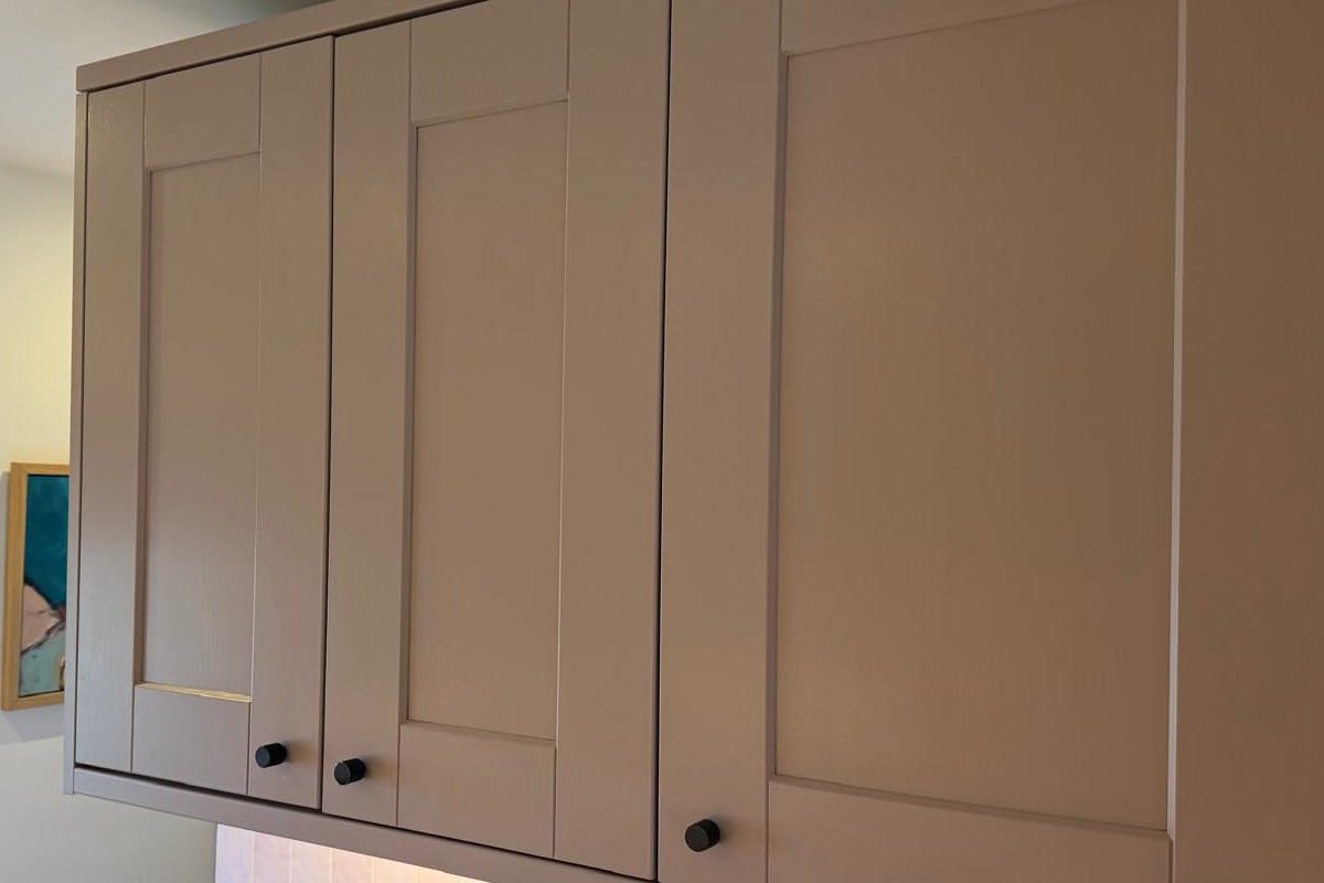The same run of wall cabinets after respraying in taupe