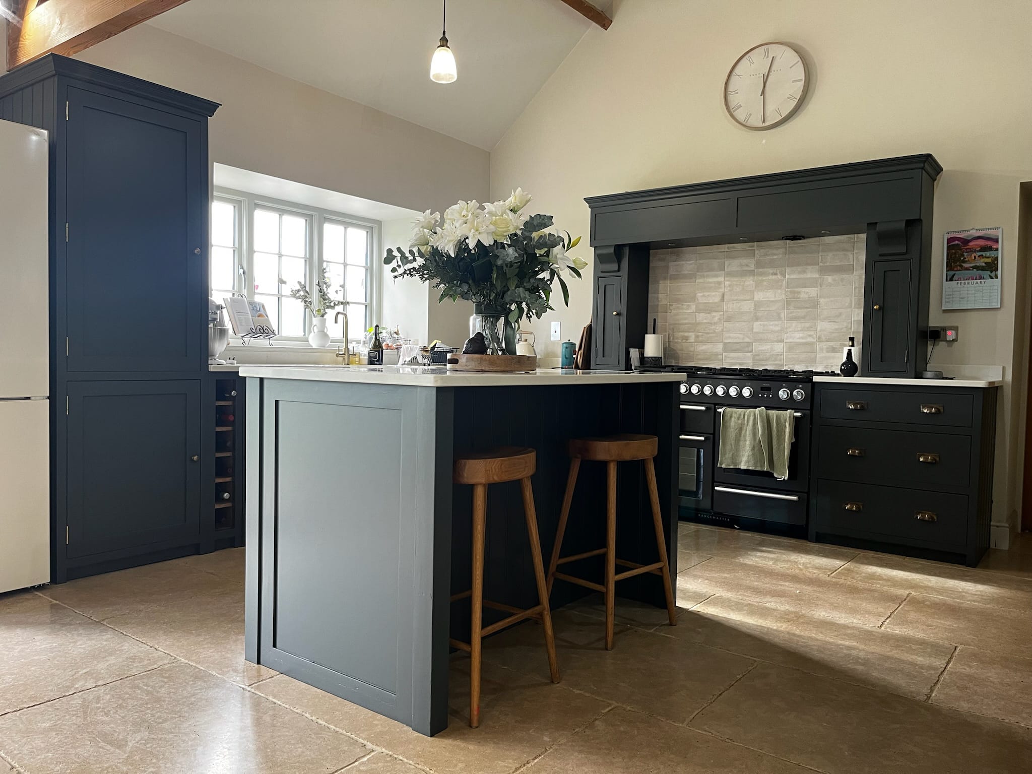 A navy blue kitchen respray with a dark green range cooker, completed by Chameleon