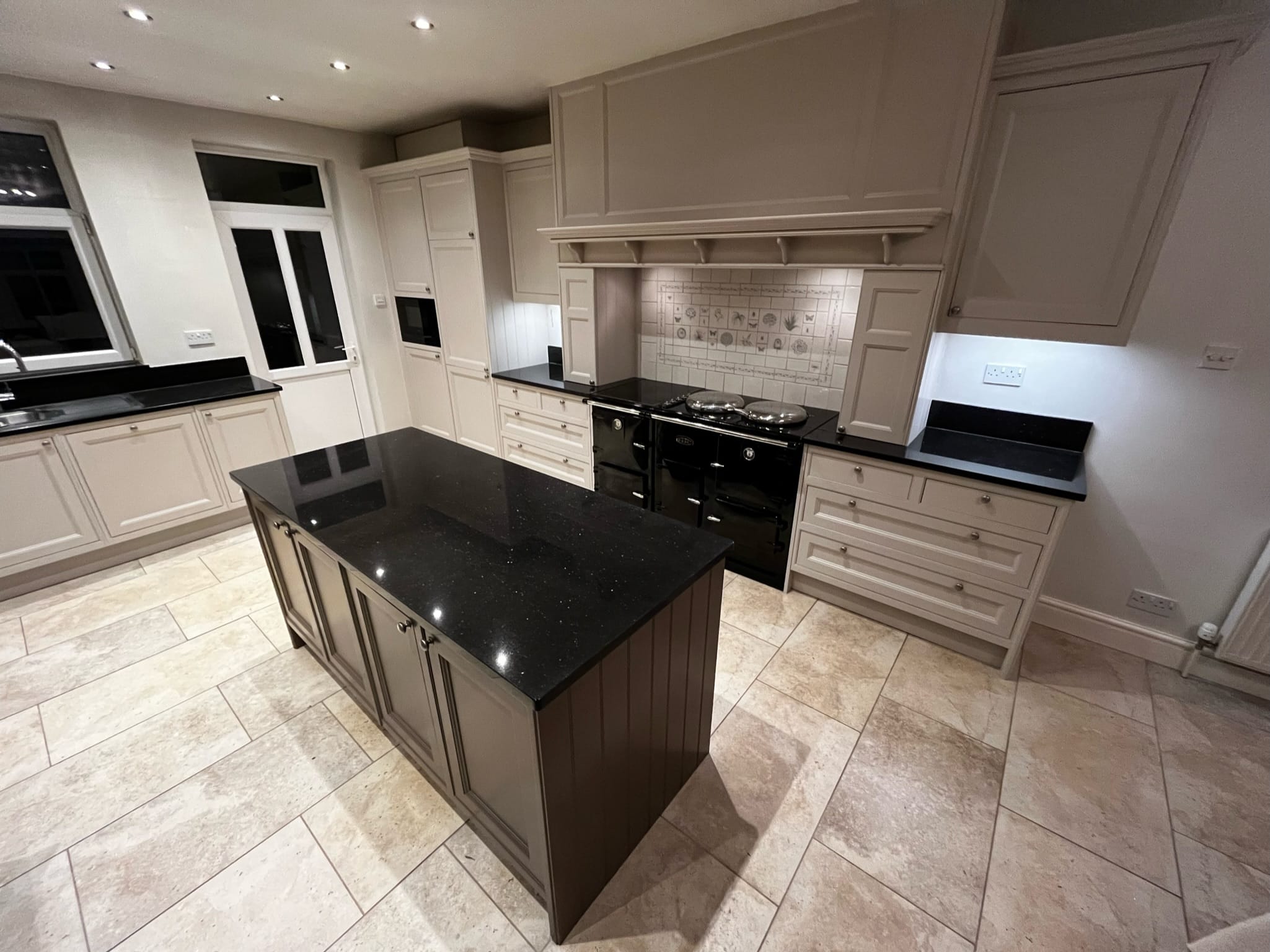 Taupe kitchen respray with black granite island and Aga range